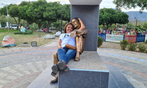 People relaxing with statues of celebrities at Valledupar Park.