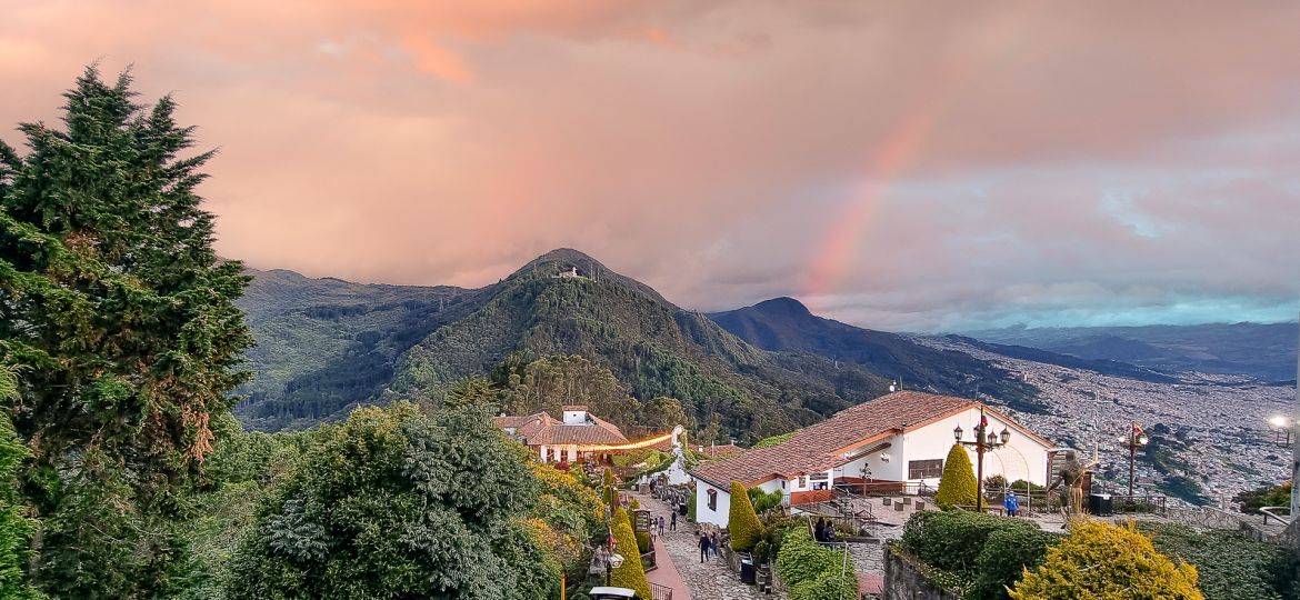 A breathtaking photograph capturing the stunning sight of a rainbow arching over the south of Monserrate, filling the sky with an explosion of vibrant colors. This image invites you to witness and revel in the natural beauty of Monserrate.