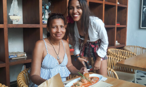 A delightful family enjoying a delicious meal at Crepes and Waffles in Cartagena, savoring the flavors of their delectable crepes and sharing joyful moments together.