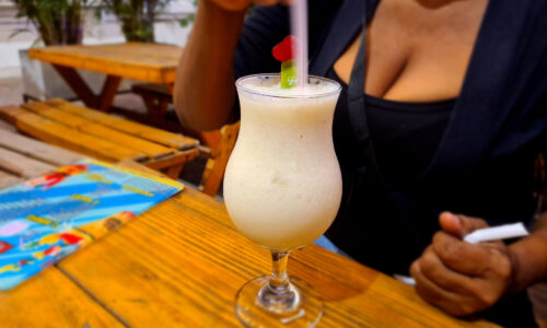 A mouthwatering Pina Colada cocktail served in a tropical paradise.